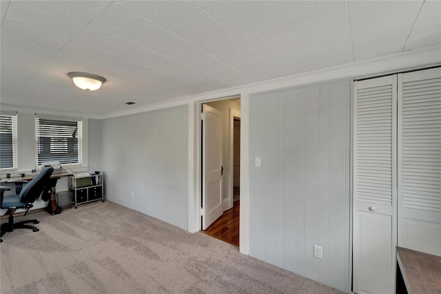 home office with carpet flooring, a textured ceiling, and ornamental molding