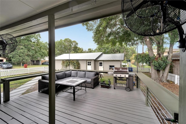 wooden terrace featuring outdoor lounge area and a grill