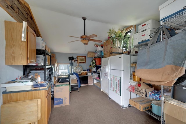 kitchen featuring ceiling fan, white refrigerator, lofted ceiling, and dark carpet