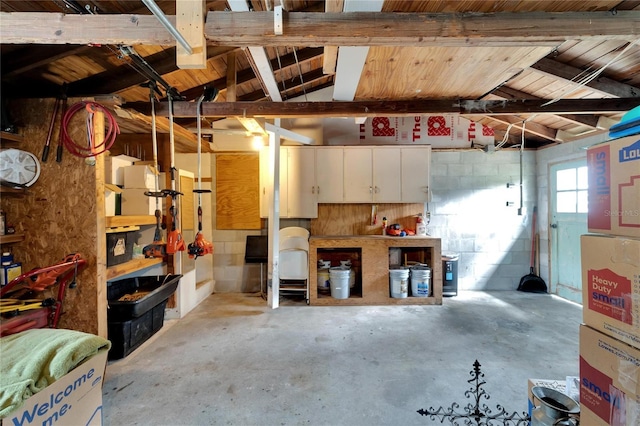 garage featuring a workshop area and wooden ceiling