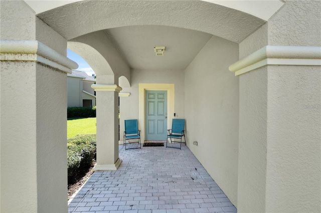 view of exterior entry with a patio