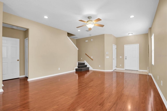 unfurnished living room featuring wood-type flooring and ceiling fan