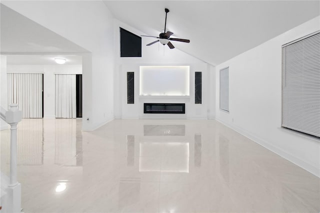 unfurnished living room featuring ceiling fan and high vaulted ceiling