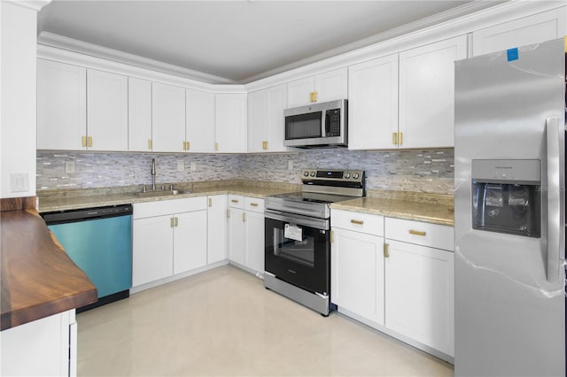 kitchen with white cabinets, crown molding, sink, decorative backsplash, and appliances with stainless steel finishes