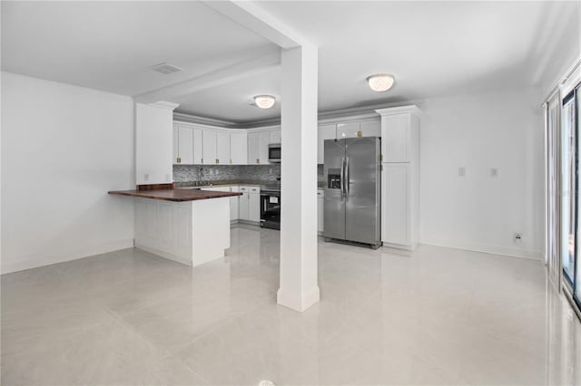 kitchen with white cabinetry, stainless steel appliances, tasteful backsplash, butcher block countertops, and kitchen peninsula