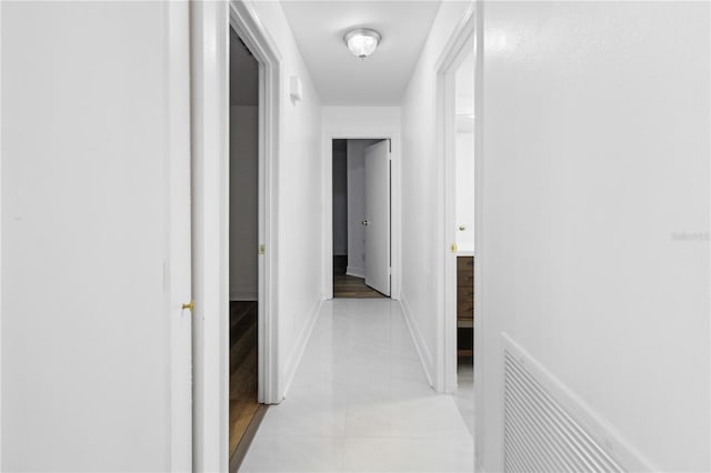 hall featuring light tile patterned floors