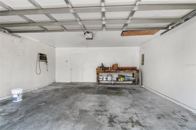 garage with a garage door opener and a wall mounted air conditioner