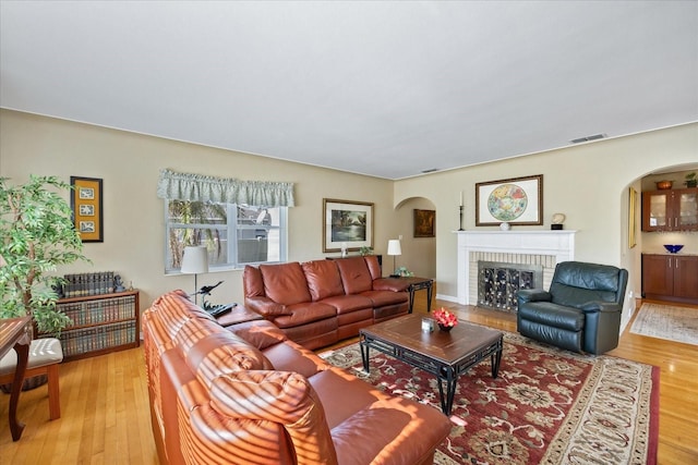 living room featuring a fireplace and light hardwood / wood-style flooring