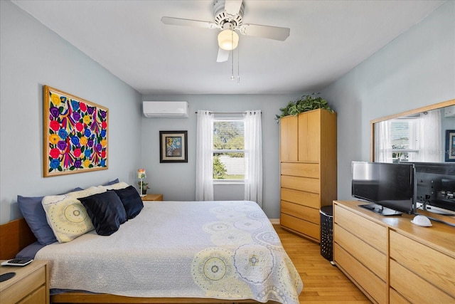 bedroom featuring a wall mounted AC, light hardwood / wood-style flooring, multiple windows, and ceiling fan