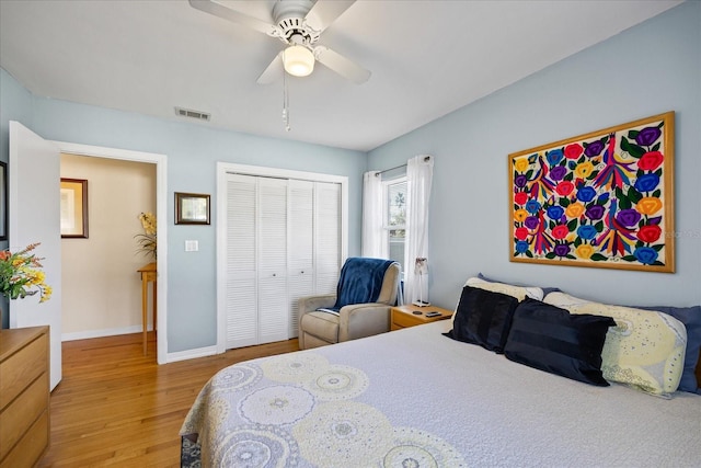 bedroom with ceiling fan, a closet, and hardwood / wood-style flooring