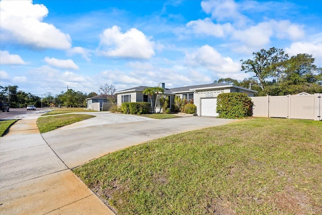 single story home with a garage and a front lawn