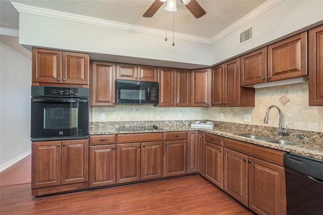 2451 Canadian Way Unit 47, Clearwater, FL 33763 - kitchen with black appliances, ornamental molding, dark wood-type flooring, light stone countertops, and ceiling fan