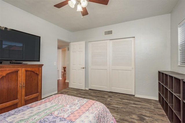 bedroom with a closet, ceiling fan, and dark wood-type flooring