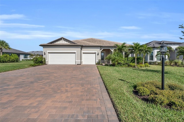 ranch-style house with a garage and a front lawn