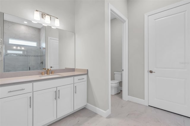 bathroom with vanity, toilet, and a shower with shower door