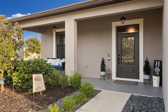 doorway to property with covered porch