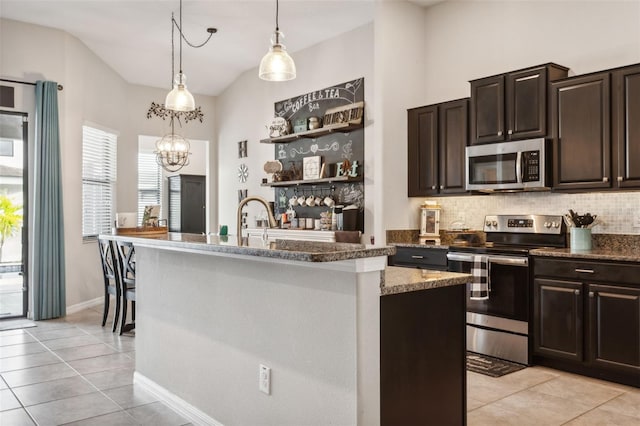 kitchen with dark brown cabinetry, stainless steel appliances, and a kitchen island with sink