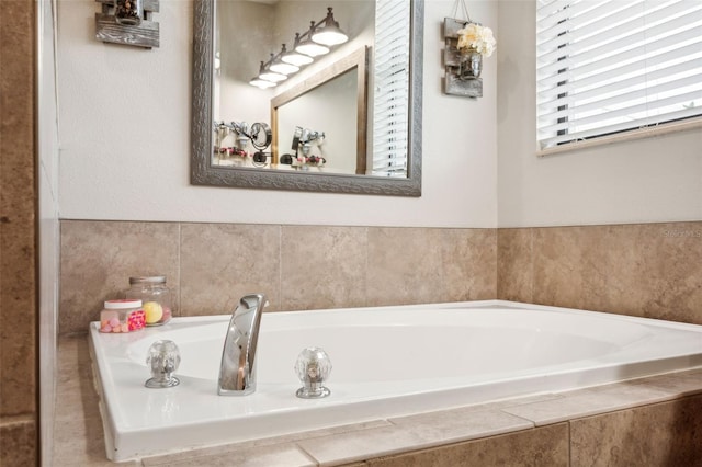 bathroom featuring tiled tub