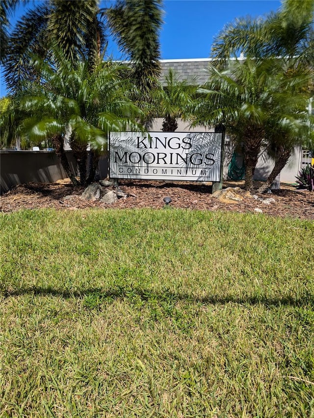 community / neighborhood sign with a lawn