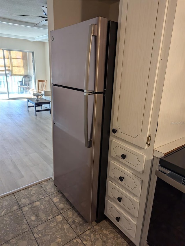 kitchen featuring stainless steel refrigerator, dark hardwood / wood-style flooring, and range