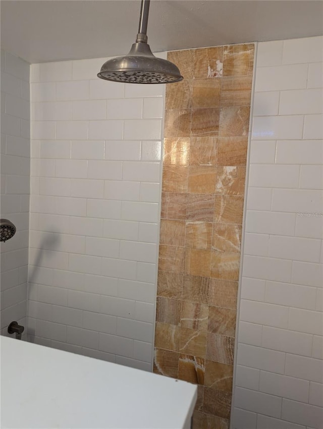 interior details featuring a tile shower