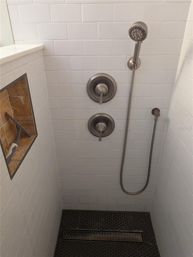 bathroom with tiled shower