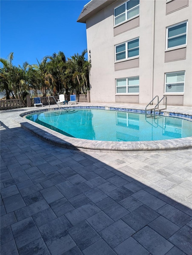 view of swimming pool with a patio