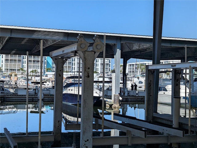 dock area featuring boat lift and a water view