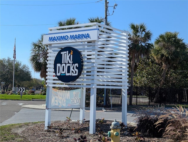 community / neighborhood sign with fence