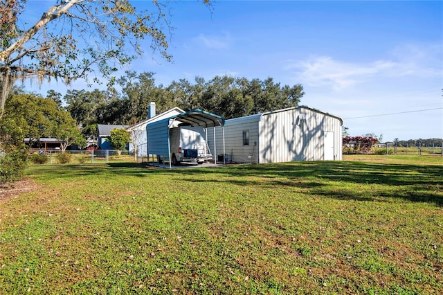 view of yard with a carport and an outdoor structure