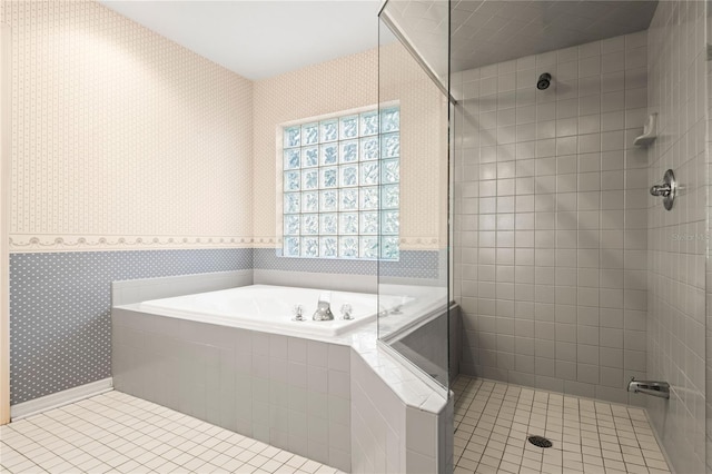 bathroom featuring tile patterned flooring and shower with separate bathtub