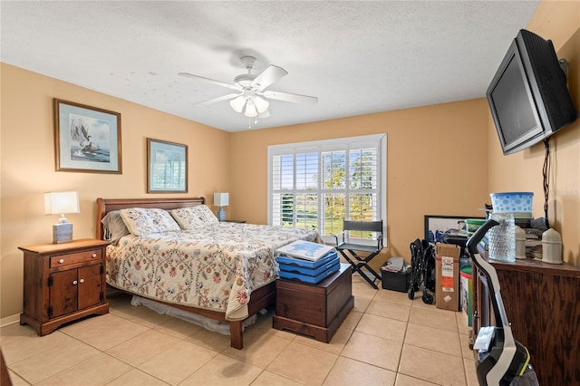 tiled bedroom with ceiling fan and a textured ceiling