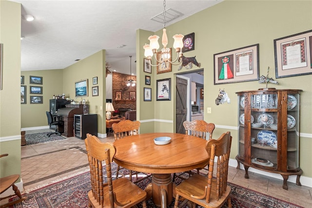 dining space featuring light tile patterned flooring, lofted ceiling, a textured ceiling, and an inviting chandelier