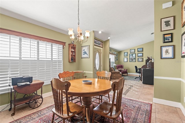 dining space with light tile patterned floors, lofted ceiling, plenty of natural light, and a notable chandelier