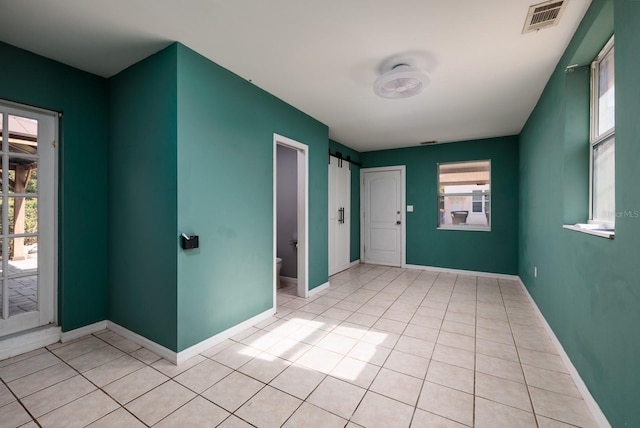 tiled foyer featuring a barn door