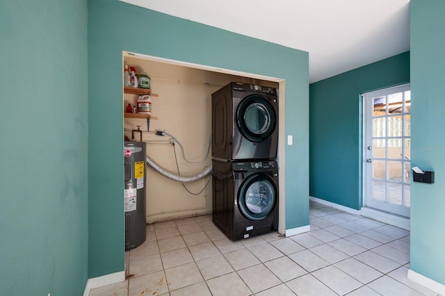 laundry area featuring stacked washer / drying machine, electric water heater, and light tile patterned floors