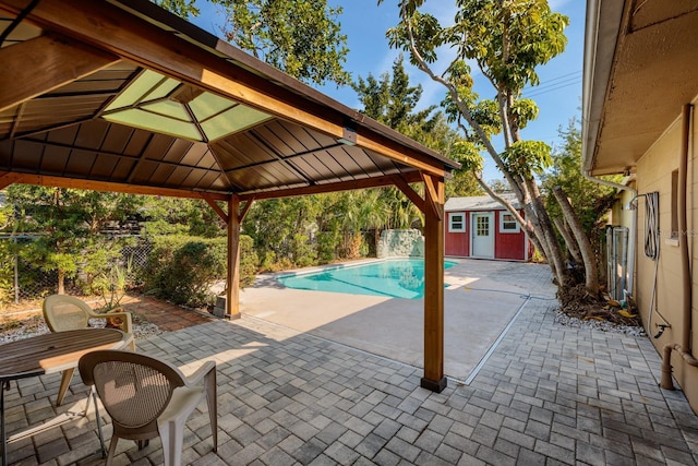 view of swimming pool featuring a gazebo, a storage unit, and a patio