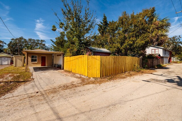 view of front of home featuring a storage unit