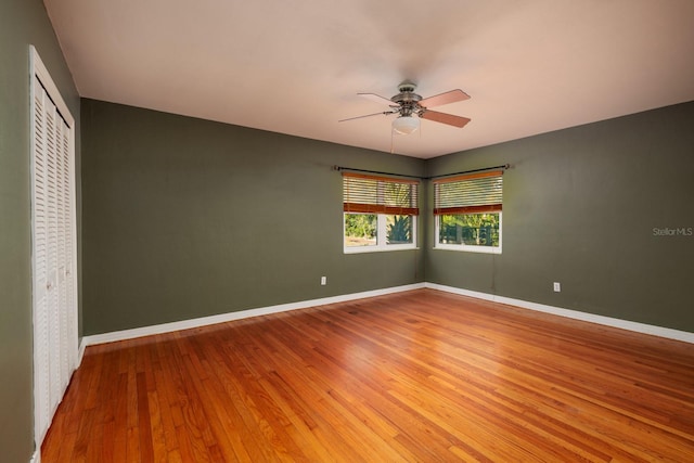 empty room with ceiling fan and wood-type flooring