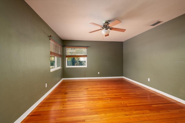 empty room with ceiling fan and light wood-type flooring