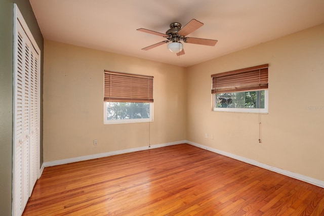 unfurnished bedroom featuring ceiling fan, light hardwood / wood-style floors, and multiple windows