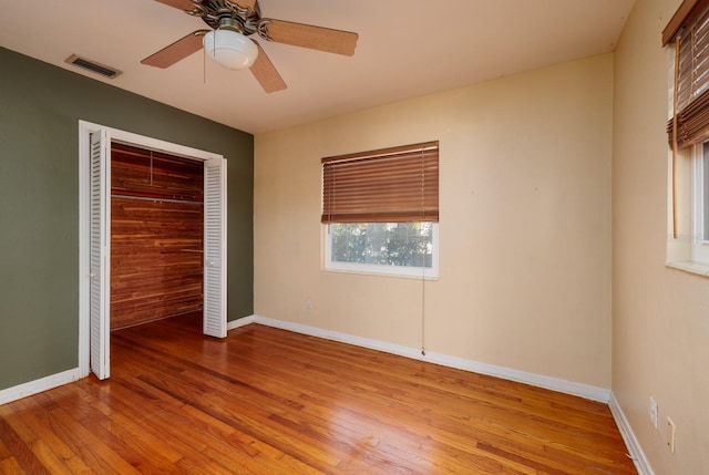 unfurnished bedroom featuring ceiling fan, light hardwood / wood-style flooring, and a closet