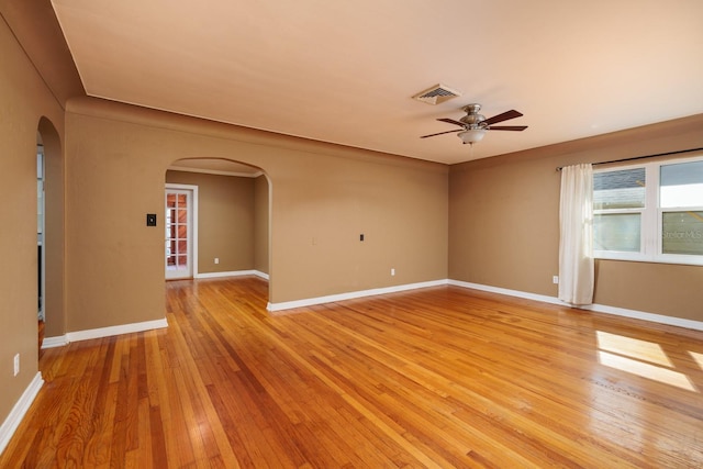 spare room with light wood-type flooring and ceiling fan