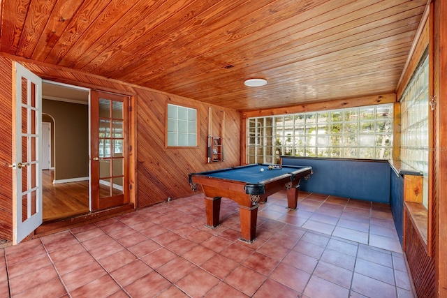 recreation room featuring french doors, wooden ceiling, tile patterned floors, wood walls, and pool table