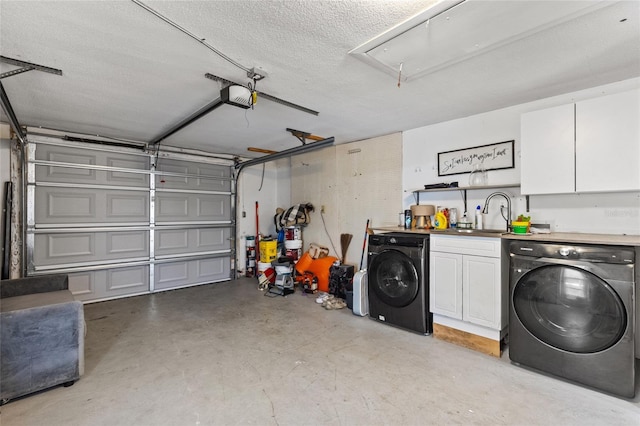 garage with washer / dryer, sink, and a garage door opener