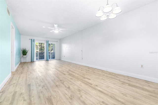 empty room with light hardwood / wood-style flooring and ceiling fan with notable chandelier