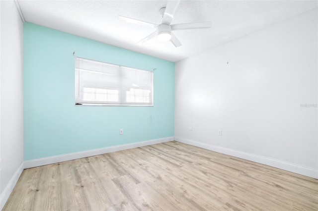 spare room featuring ceiling fan, a textured ceiling, and light wood-type flooring