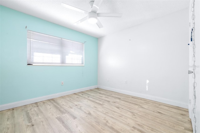 unfurnished room featuring a textured ceiling, light hardwood / wood-style floors, and ceiling fan