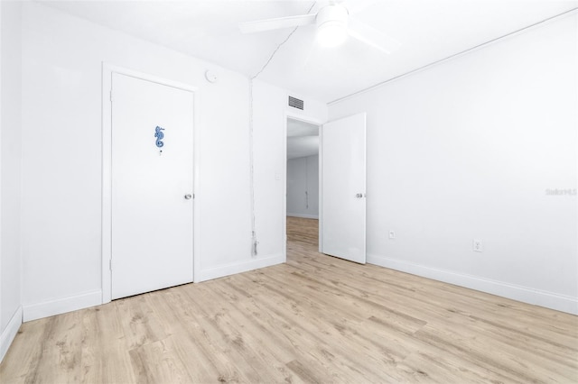 unfurnished bedroom with ceiling fan and light wood-type flooring