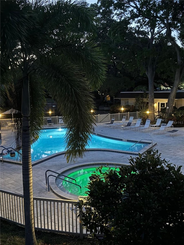 view of swimming pool with a patio area and a hot tub